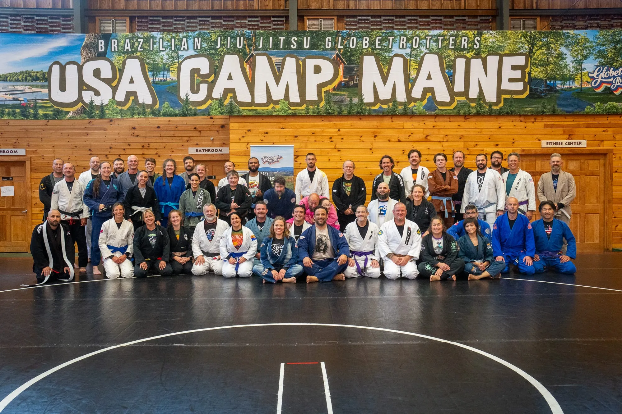 Large group of Brazilian Jiu Jitsu practitioners gathered on the mats at the BJJ Globetrotters USA Camp in Maine.
