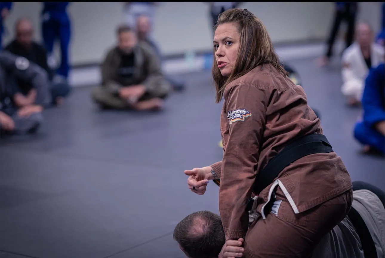 Missy Baize demonstrates a control position while teaching a Brazilian Jiu Jitsu seminar.